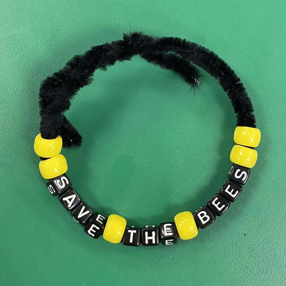 A bead bracelet that says, "Save the Bees."
